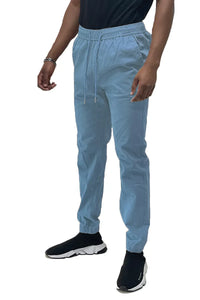 Front view of solid jogger pants with elastic waistband and pockets laid flat on a white surface.