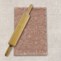 Close-up of Copper Magnolia Tea Towel showing textured cotton twill fabric and copper magnolia print.