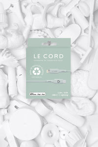 Close-up of recycled TPE connector shell and cable sleeve with natural pale pine color in recyclable packaging.