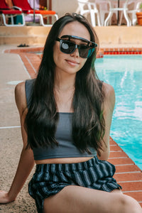 Flipside Sunglasses folded flat showing frame thickness and visor mechanism.