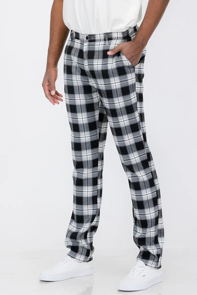 Front view of slim fit plaid trouser pants with button fly and standard pockets on model.