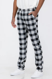 Front view of slim fit plaid trouser pants with button fly and standard pockets on model.