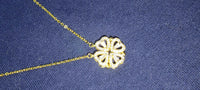 Detailed close-up of the four-leaf clover and heart shape necklace pendant with high gloss polish.