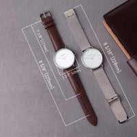 Leather watch band with six adjustable holes laid out next to stainless steel watch case.