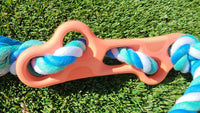 Close-up of high-quality natural rubber dog bone chew toy with durable tug rope.