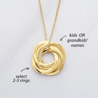 Silver interlocking rings necklace displayed on a white background, showing multiple polished circular pendants.