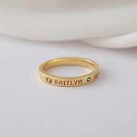 Close-up view of a silver ring with custom engravings, ideal as a new mom gift.