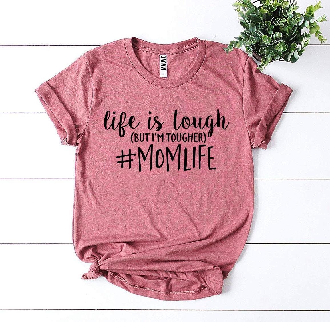 Folded white #Momlife T-shirt showing smooth knit texture