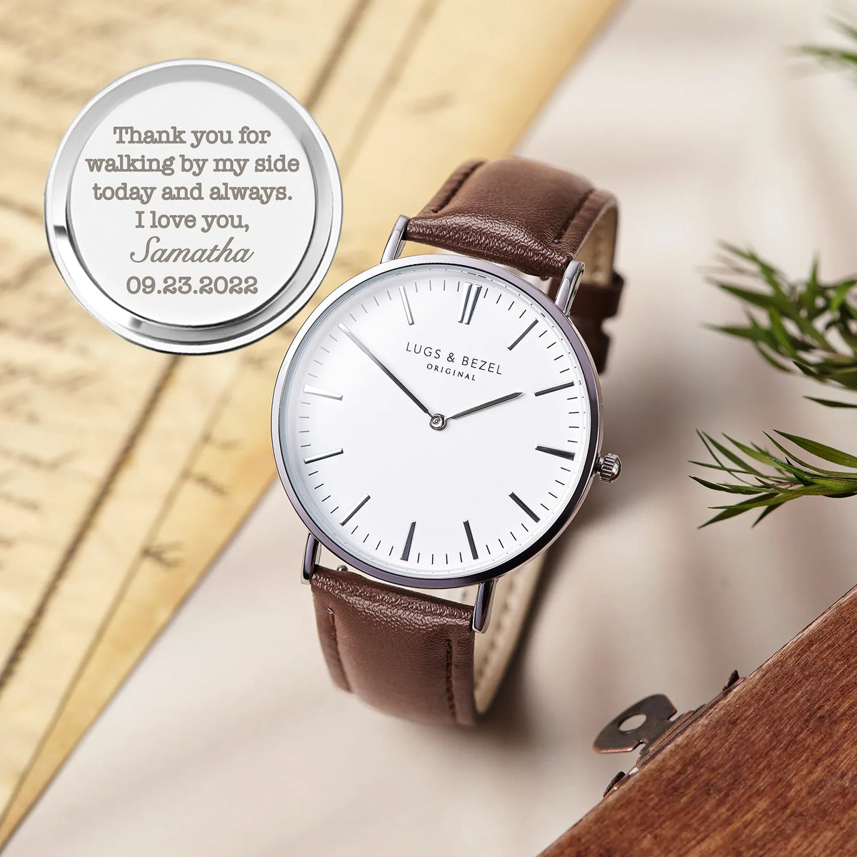 Side view of men's watch showing copper face and leather buckle strap.