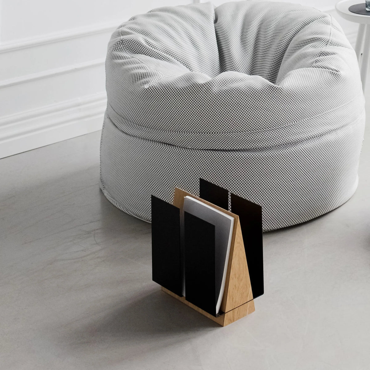 Side view of WINGS magazine rack showcasing the wing-shaped metal panels partially hiding magazines.