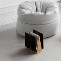 Side view of WINGS magazine rack showcasing the wing-shaped metal panels partially hiding magazines.