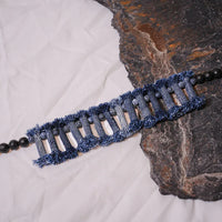 Denim necklace and bracelet set arranged on white background showcasing tribal design and natural stones.