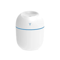 Hand holding pink portable USB ultrasonic humidifier with glowing LED light.