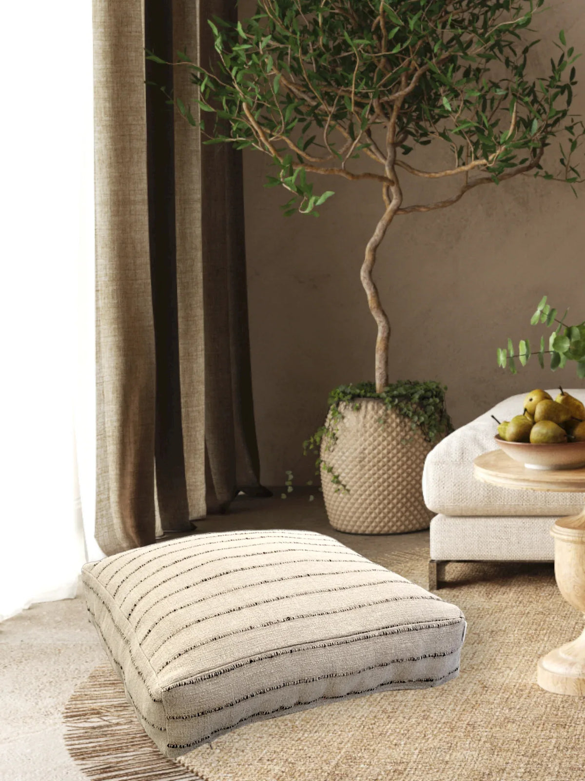 Top view of Nomad Floor Cushion showing natural linen and jute fabric with 3D stripes.