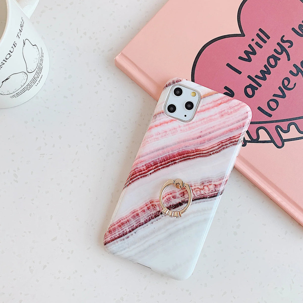 Side view of marble iPhone case showing soft raised edges for screen protection.