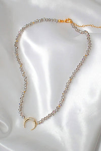 Light blue crystal choker necklace displayed on a white background showing its delicate design and shimmer.