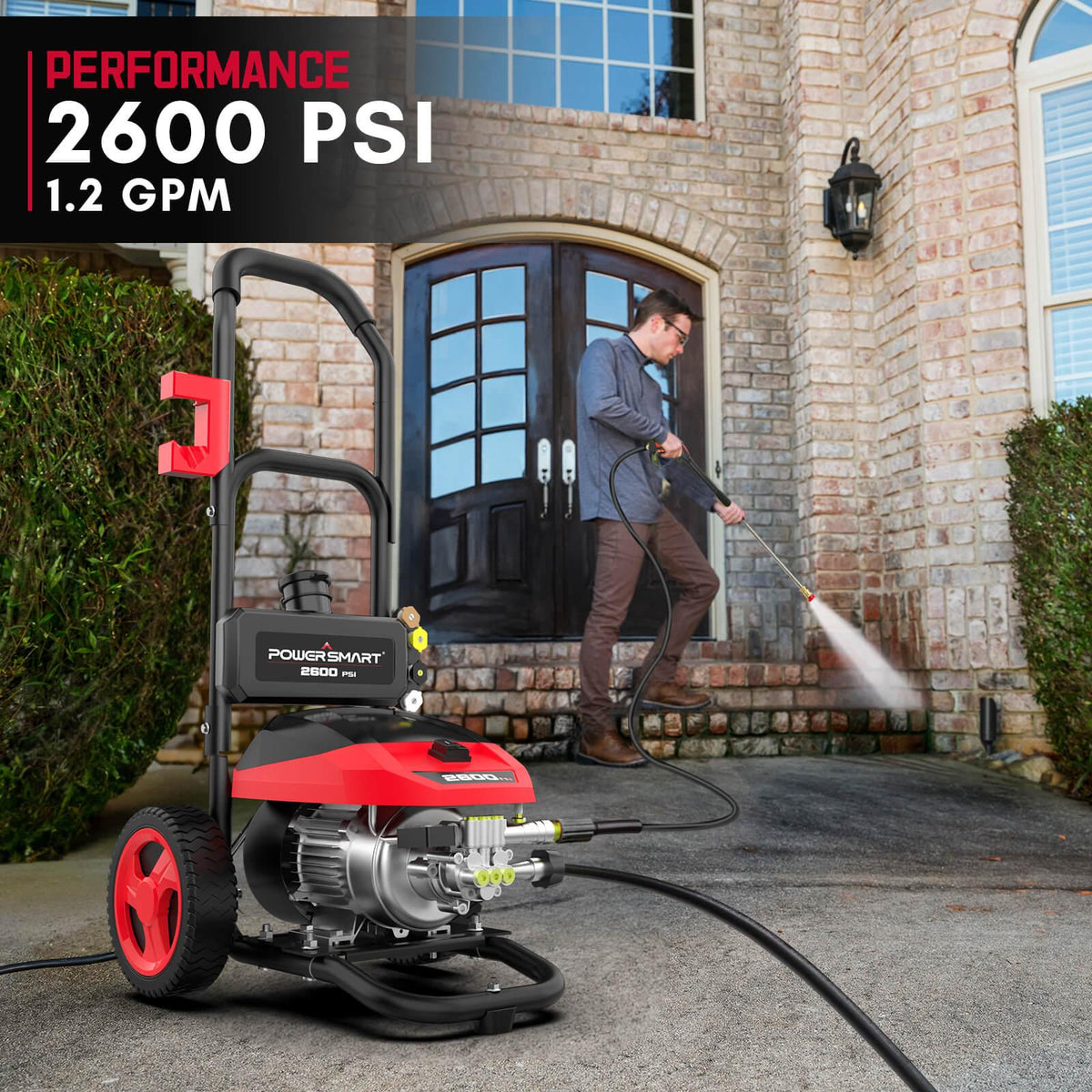 User holding pressure washer wand spraying water on a driveway for cleaning.