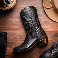 Denver Black boots styled with casual outfit on a person walking on stone pavement.