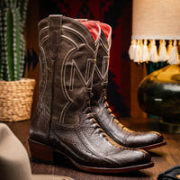 Lifestyle shot of a person wearing Denver ostrich leather cowboy boots with jeans outdoors.