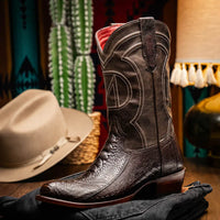 Denver boot worn with blue jeans, showing the boot’s shaft and vibrant finish walking on pavement.