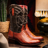 Model wearing Denver Rustic Cognac cowboy boots with jeans sitting on wooden steps outdoors.