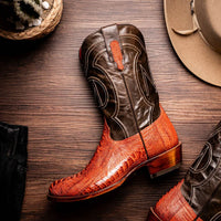 Denver Rustic Cognac cowboy boots in outdoor setting with natural lighting on wooden surface.