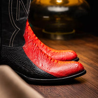 Man wearing Denver red and black ostrich leg boots with jeans outdoors.