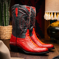 Model wearing Denver Red boot standing outdoors, showcasing black leather shaft and red stitching.