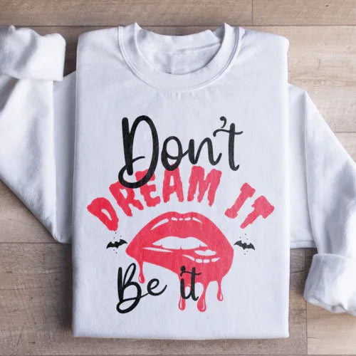 White sweatshirt with fleece lining and 'Don't Dream It' text, warm and cozy design.