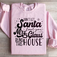 Light pink sweatshirt featuring 'Don't Let Santa Fool You Mrs Claus Run This House' graphic