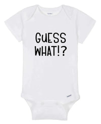 Close-up of white baby onesie fabric showing colorful 'Guess What!? Chicken Butt' print.