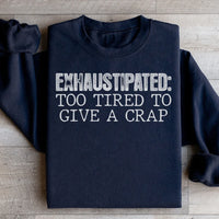 Black sweatshirt with peach text reading Exhaustipated To Tired To Give A Crap in a casual font.