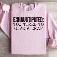 Light pink sweatshirt with peach text reading Exhaustipated To Tired To Give A Crap in bold design.
