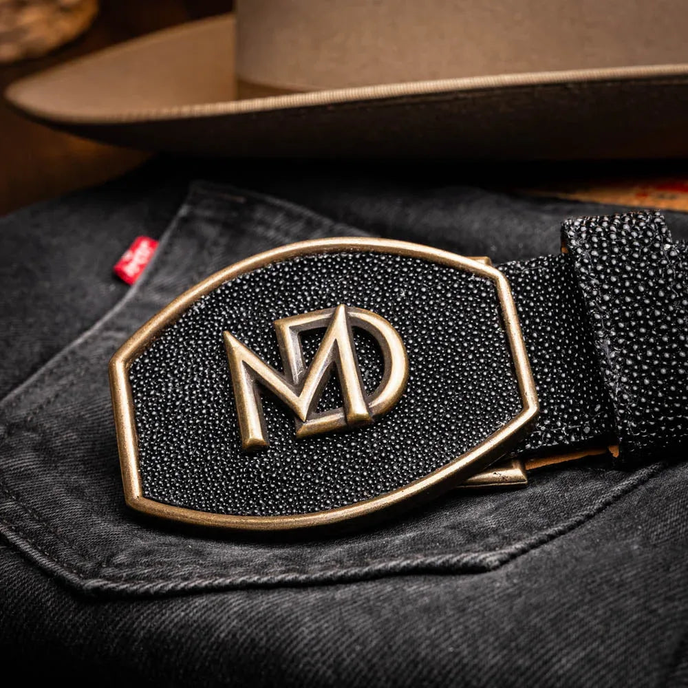 Black stingray belt styled with leather boots and casual attire outdoors