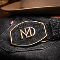 Black stingray belt styled with leather boots and casual attire outdoors