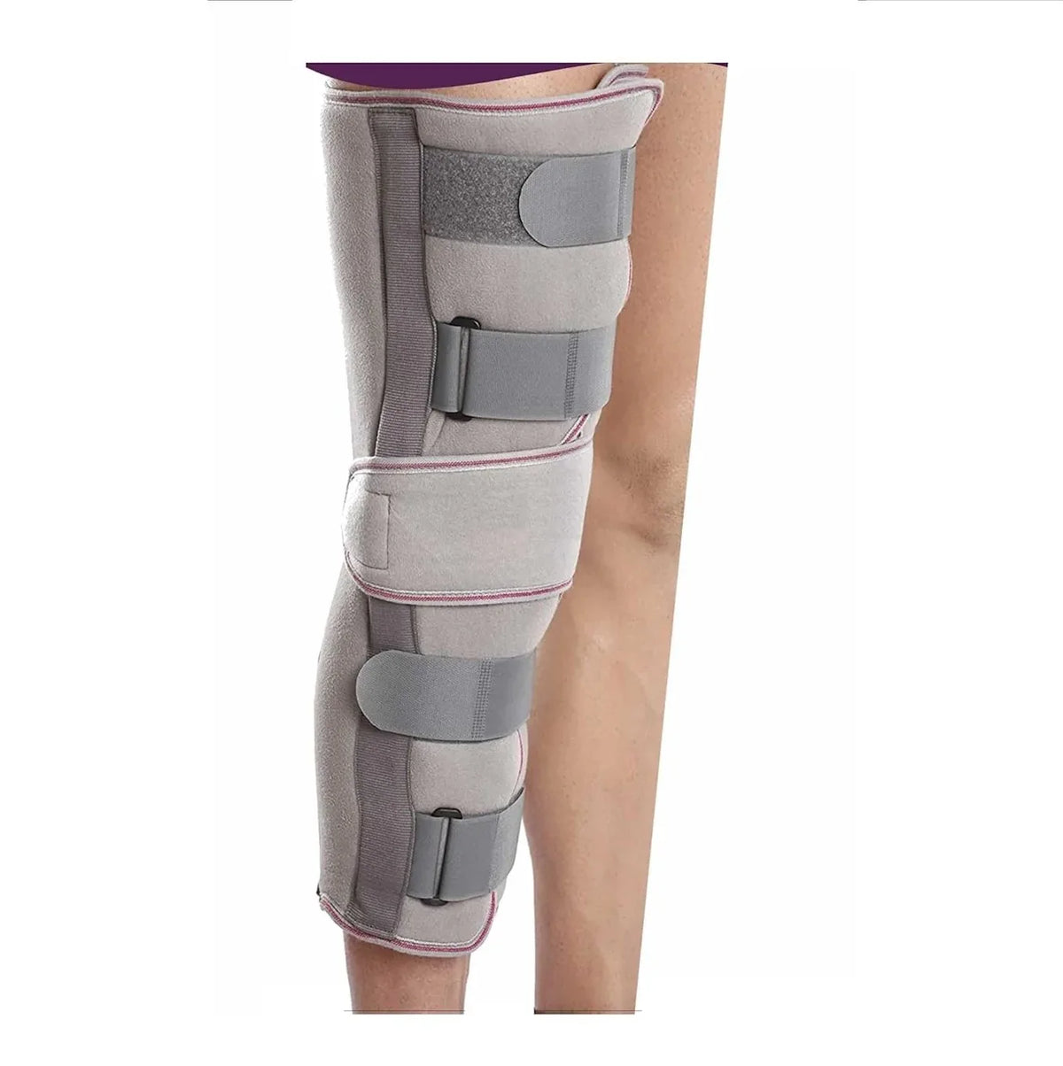White cotton knee immobilizer brace with adjustable straps on a plain background