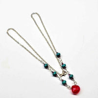 Turquoise magnesite and fuchsia chalcedony gemstones on 14K gold-filled drop necklace.