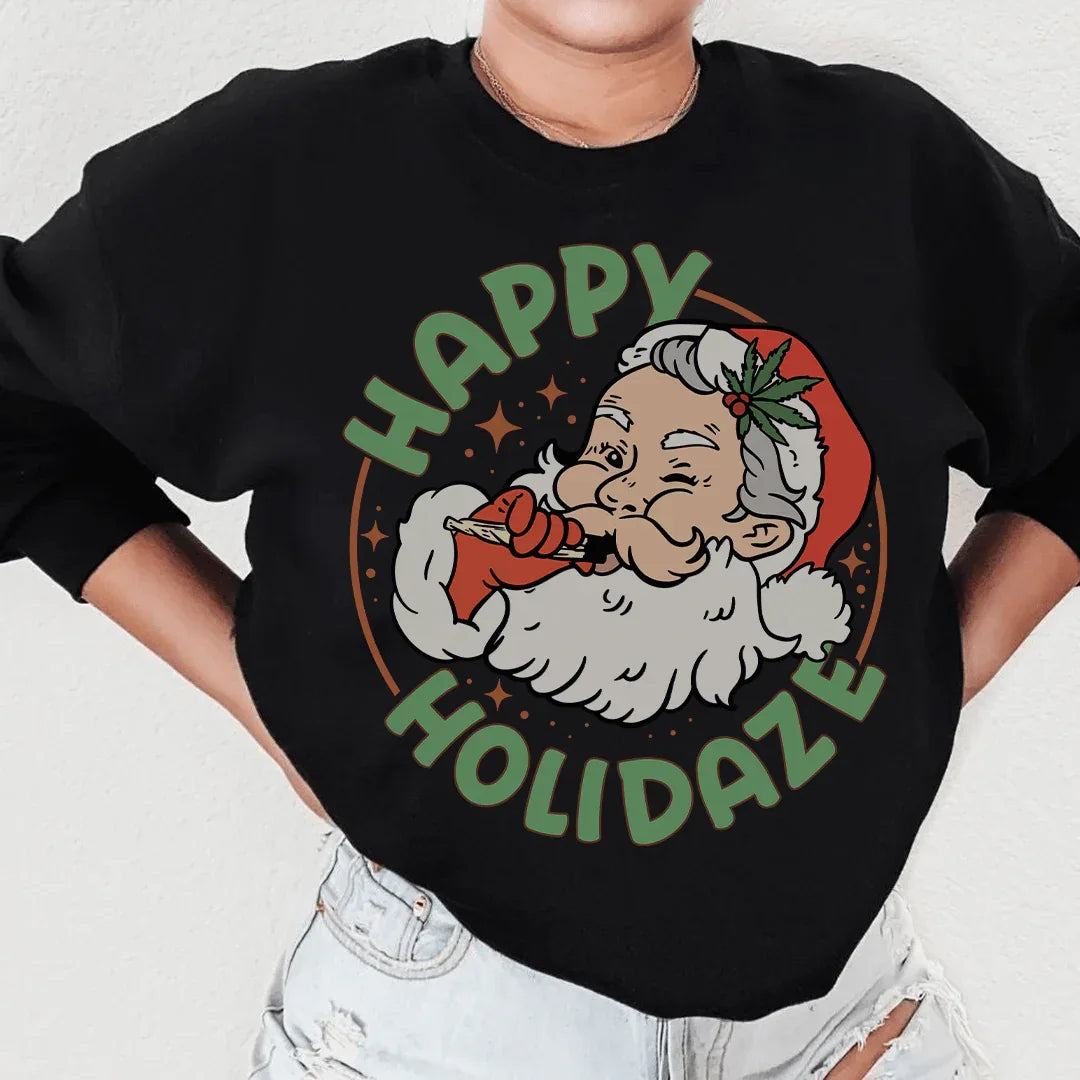 Front view of peachy Sunday sweatshirt with Happy Holidaze graphic in warm tones.