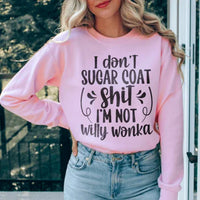 Light pink sweatshirt with white 'I'm Not Willy Wonka' lettering, shown flat on neutral surface.