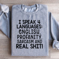 Peach colored sweatshirt with the phrase I Speak Four Languages printed in white text.