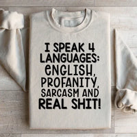 Front view of peach sweatshirt featuring the bold phrase I Speak Four Languages.