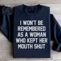 Black sweatshirt with bold white text: 'I Won't Be Remembered As A Woman Who Kept Her Mouth Shut'.