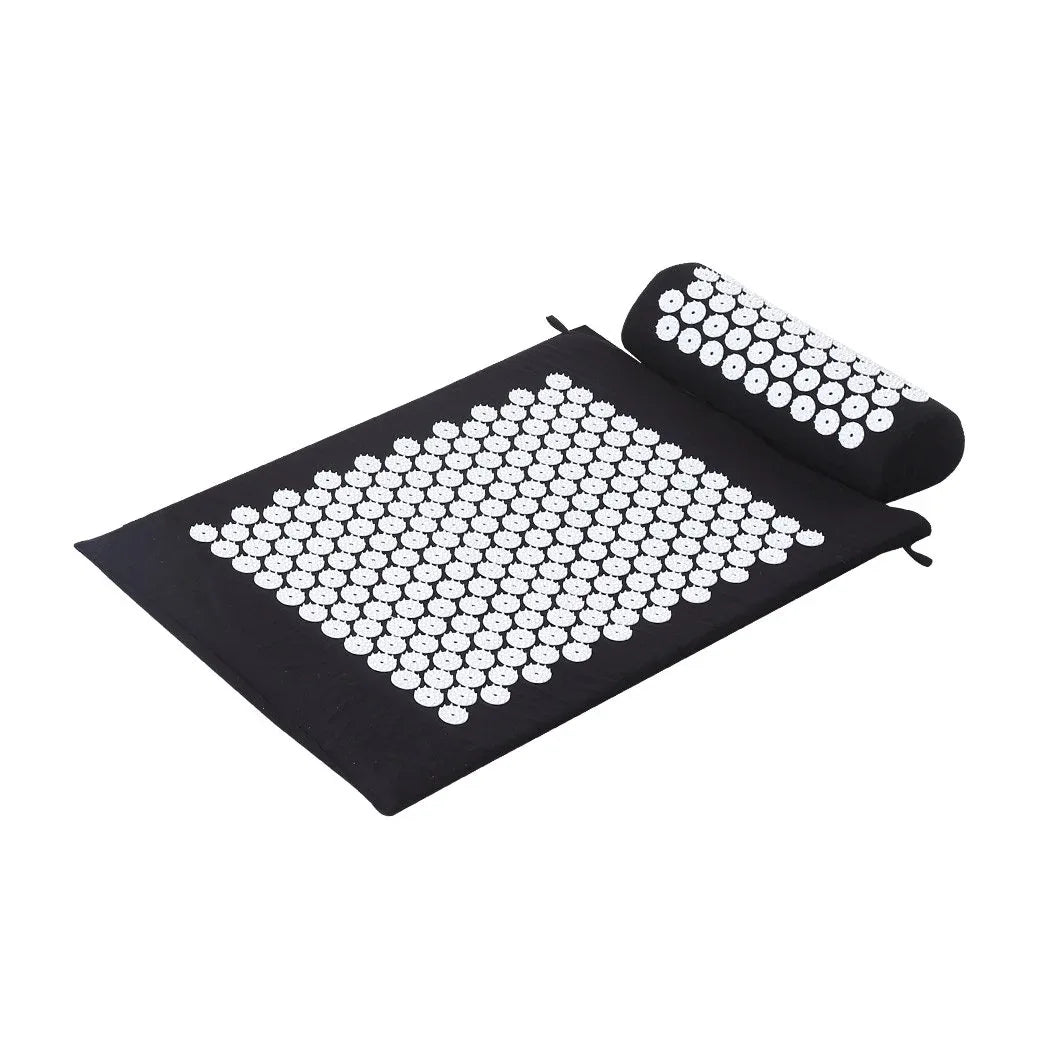 Black acupressure mat with tiny plastic spikes for pain relief and stress reduction