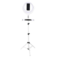 12-inch LED ring light mounted on a tripod with phone holder, showing the ring light illuminated.