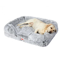 Orthopedic pet bed in soft beige plush fabric, shaped with supportive bolsters for dogs
