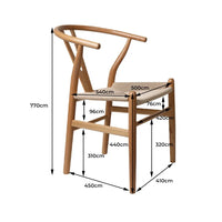 Single wooden dining chair with rattan seat viewed from front on a plain backdrop.