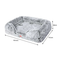 Orthopedic pet bed placed on wooden floor showcasing supportive bolster pillow