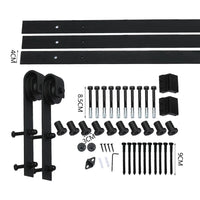Close-up showing detailed metal rollers and track of vintage-style barn door hardware.