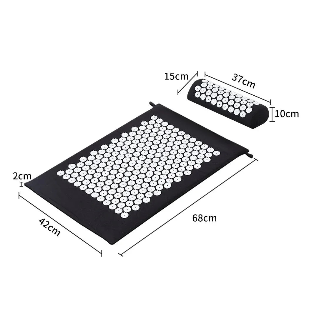 Close-up of hands touching textured spikes of black acupressure treatment mat
