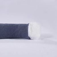 Hand gently touching the chunky knit blanket to demonstrate its soft and smooth texture.
